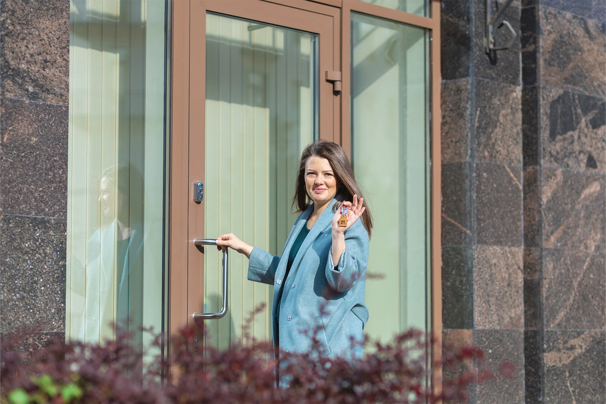 dearborn - woman waving in front of door