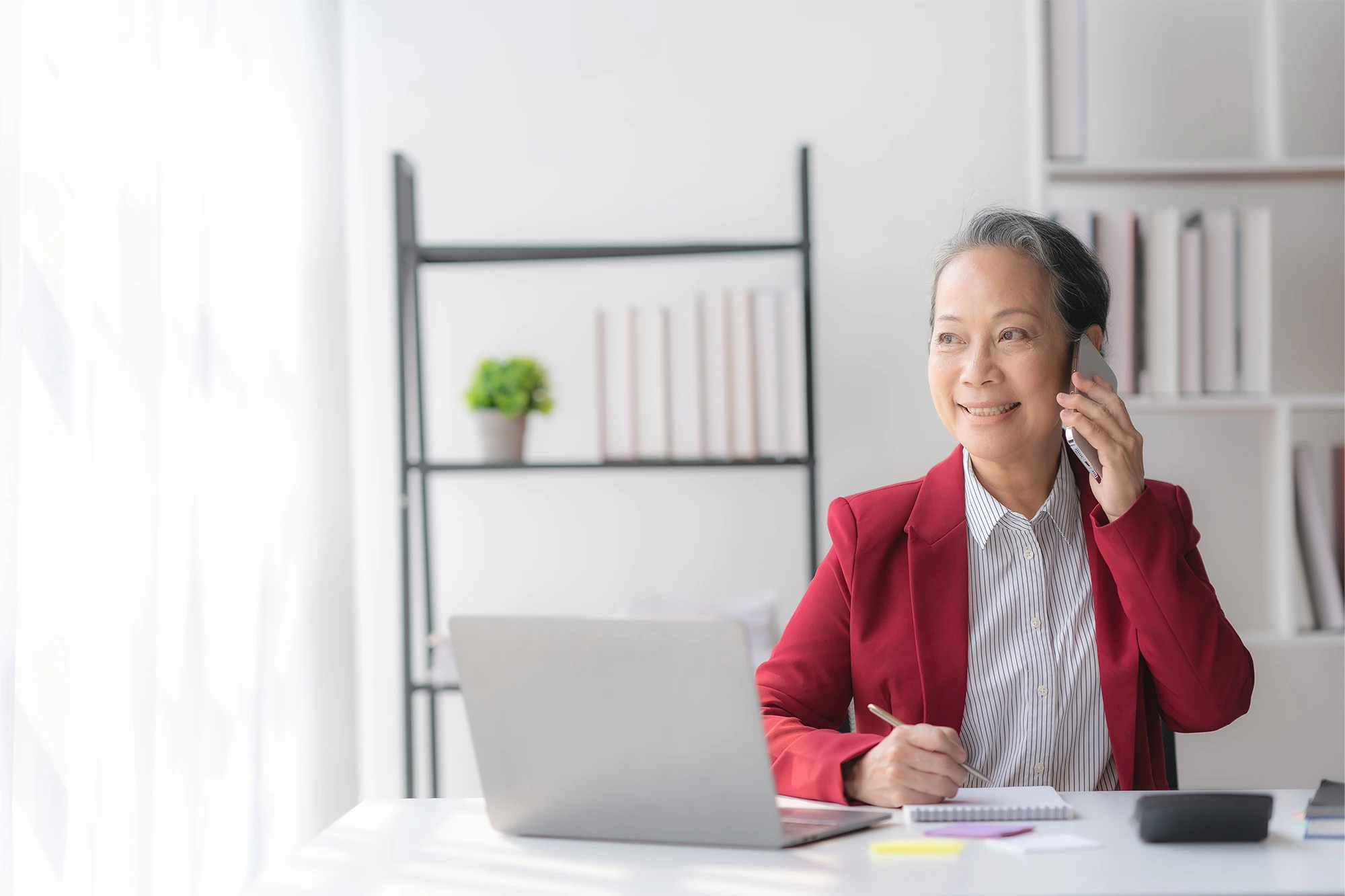 dearborn - woman with laptop on cellphone
