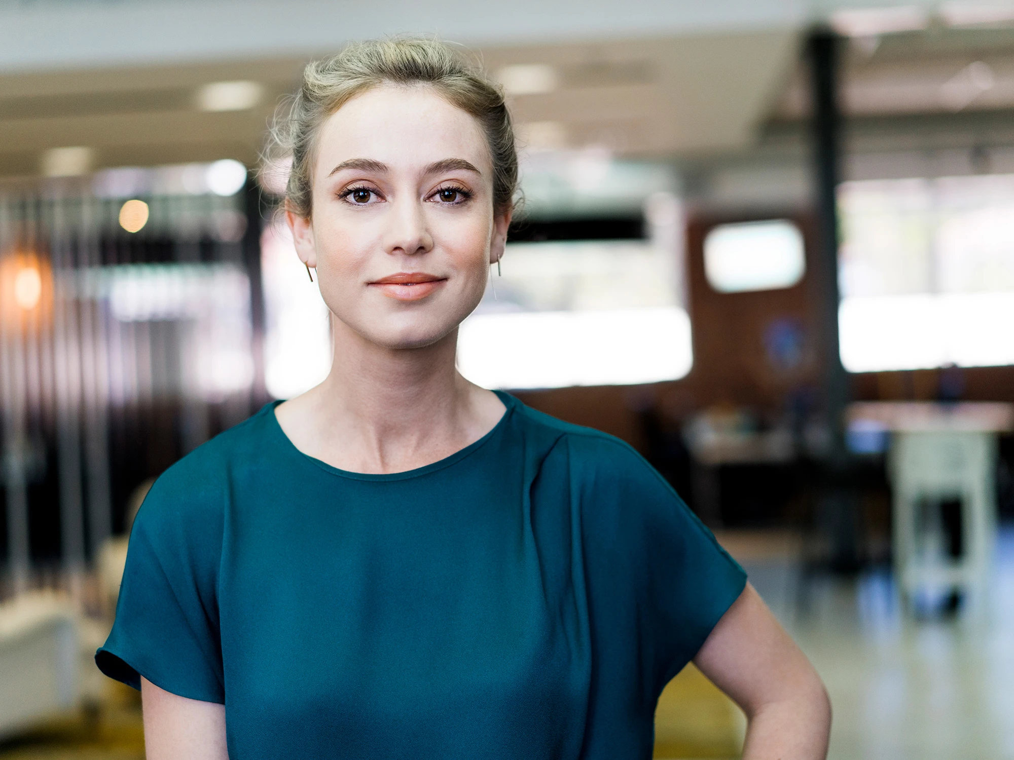 Female student standing in work environment