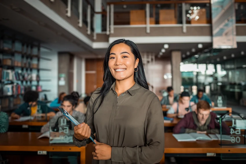 Female university student standing in a library