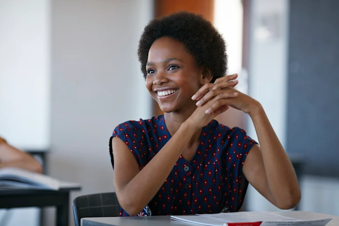 A smiling student in a classroom