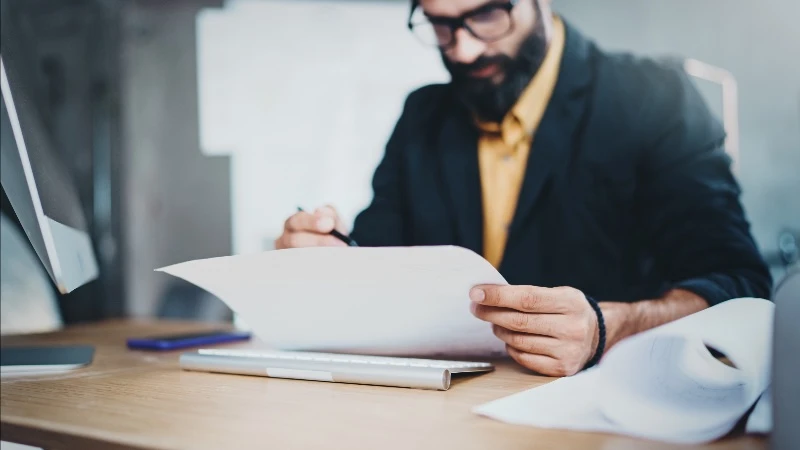 business man looking at paper 