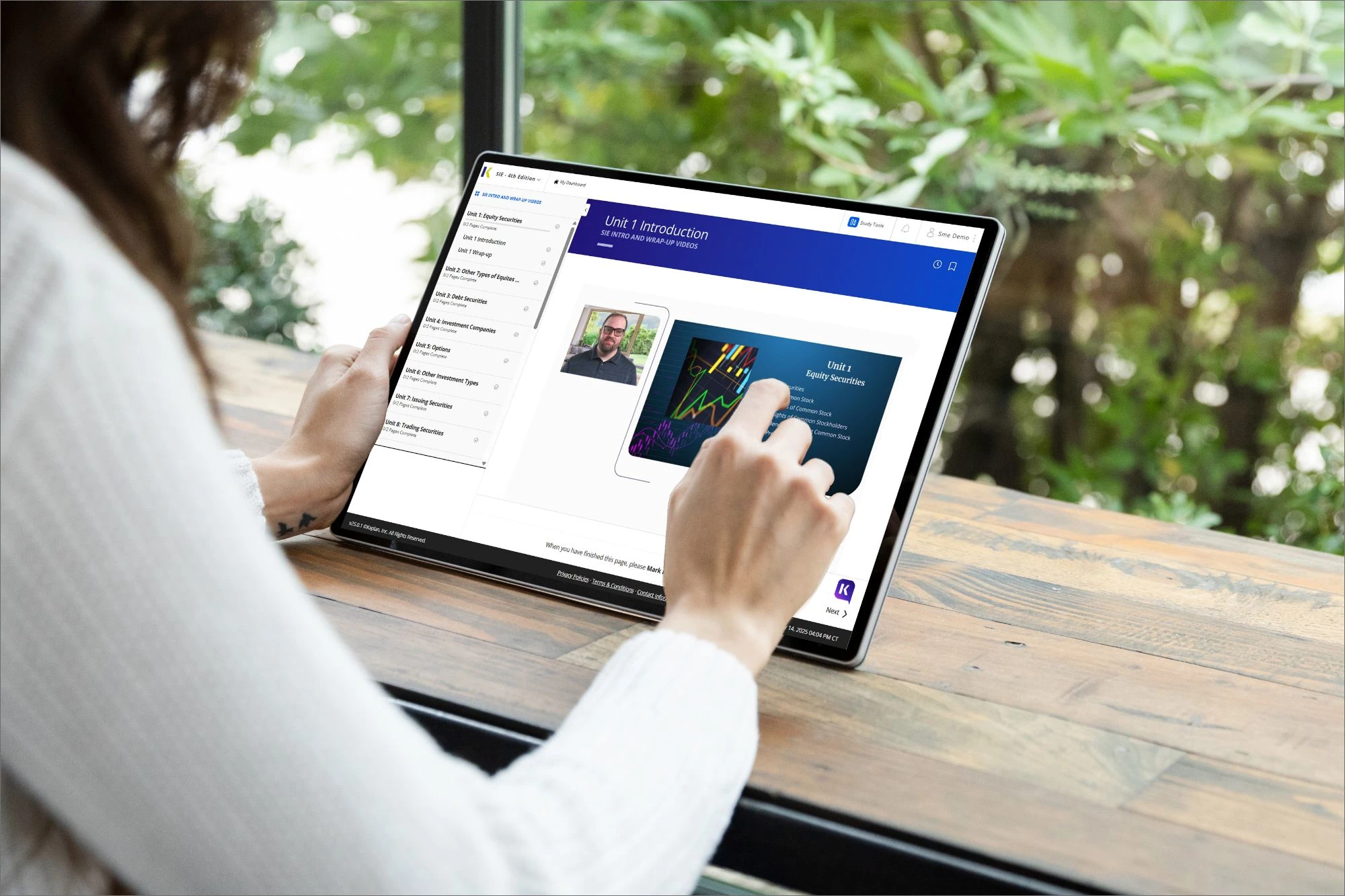 woman studying for securities exam on tablet