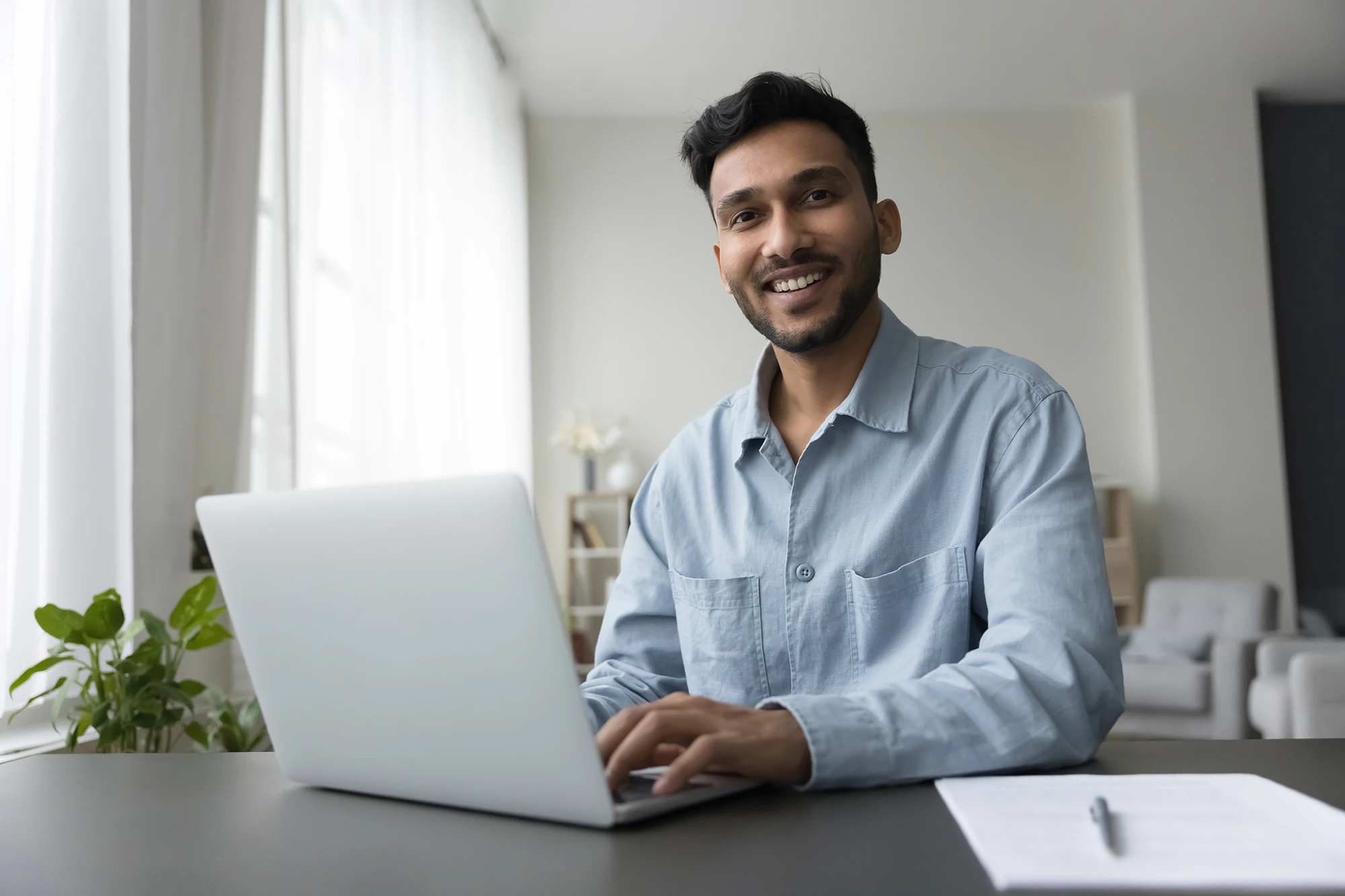 cfa-india-man-smiling-at-laptop