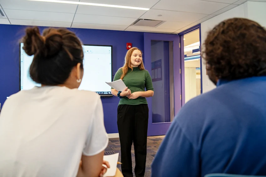 Work With Us - Kaplan North America - woman speaking in front of room