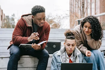 A group of students looking at a laptop