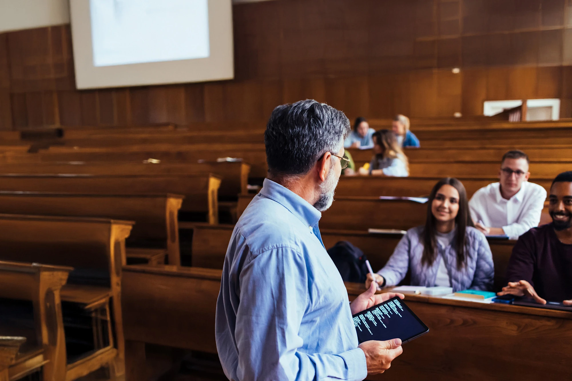 college professor and students in lecture hall
