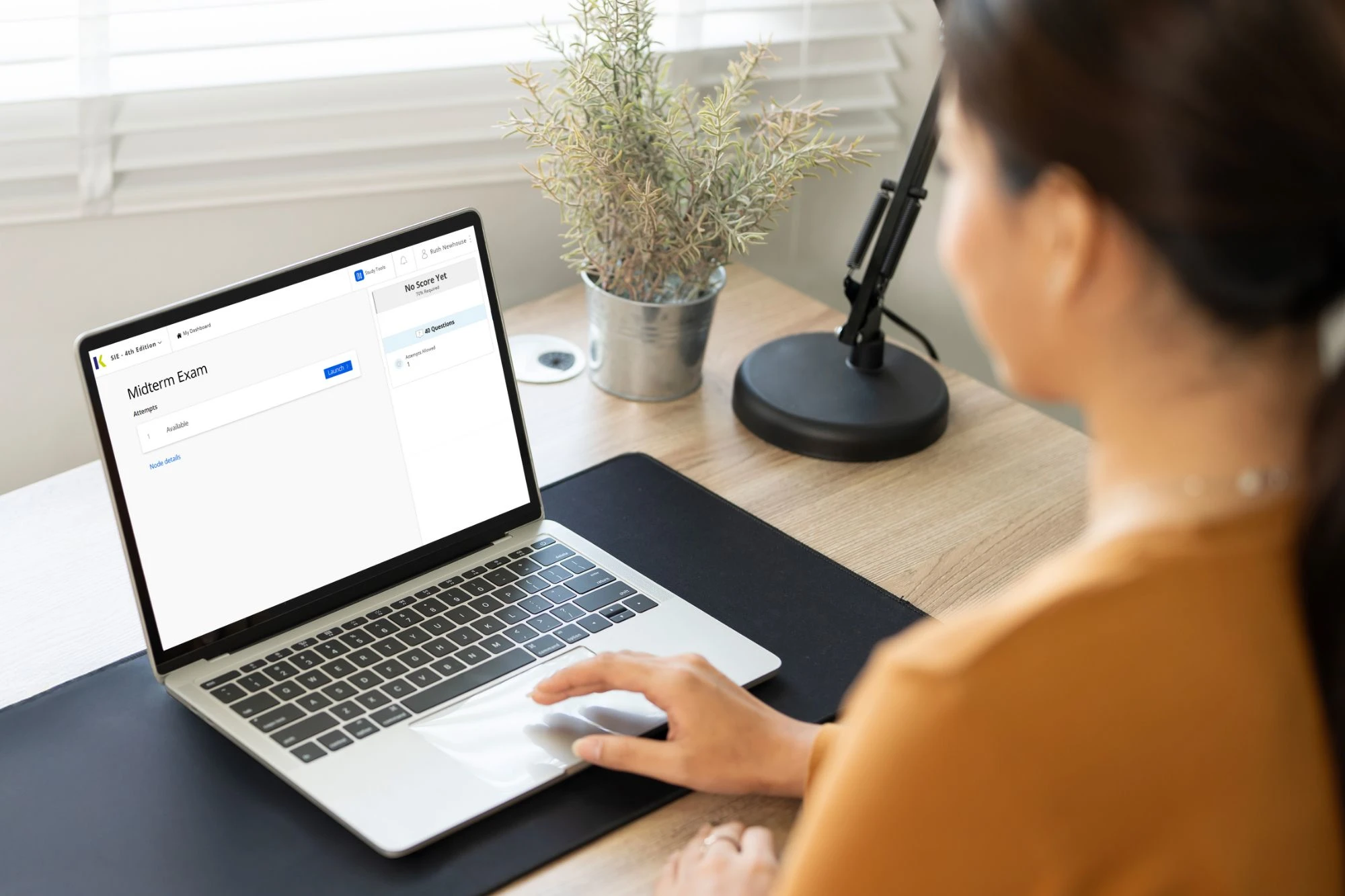 woman on laptop studying for securities exam