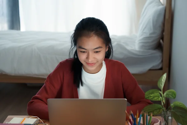 A young female student looking at her computer