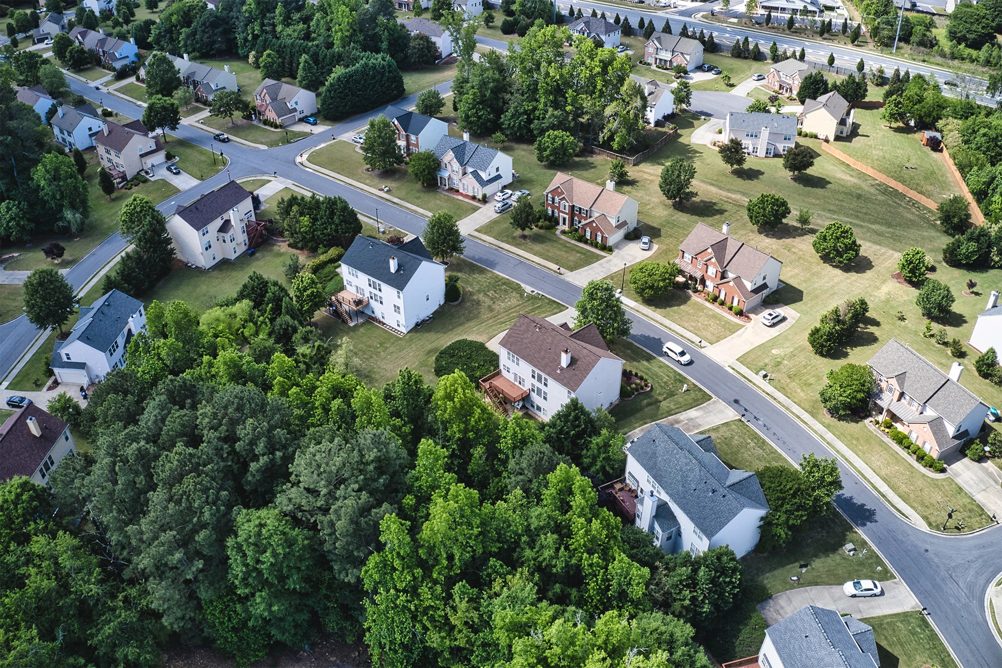 Aerial view of a residential neighborhood with buildings and streets, often used by real estate professionals for market analysis.
