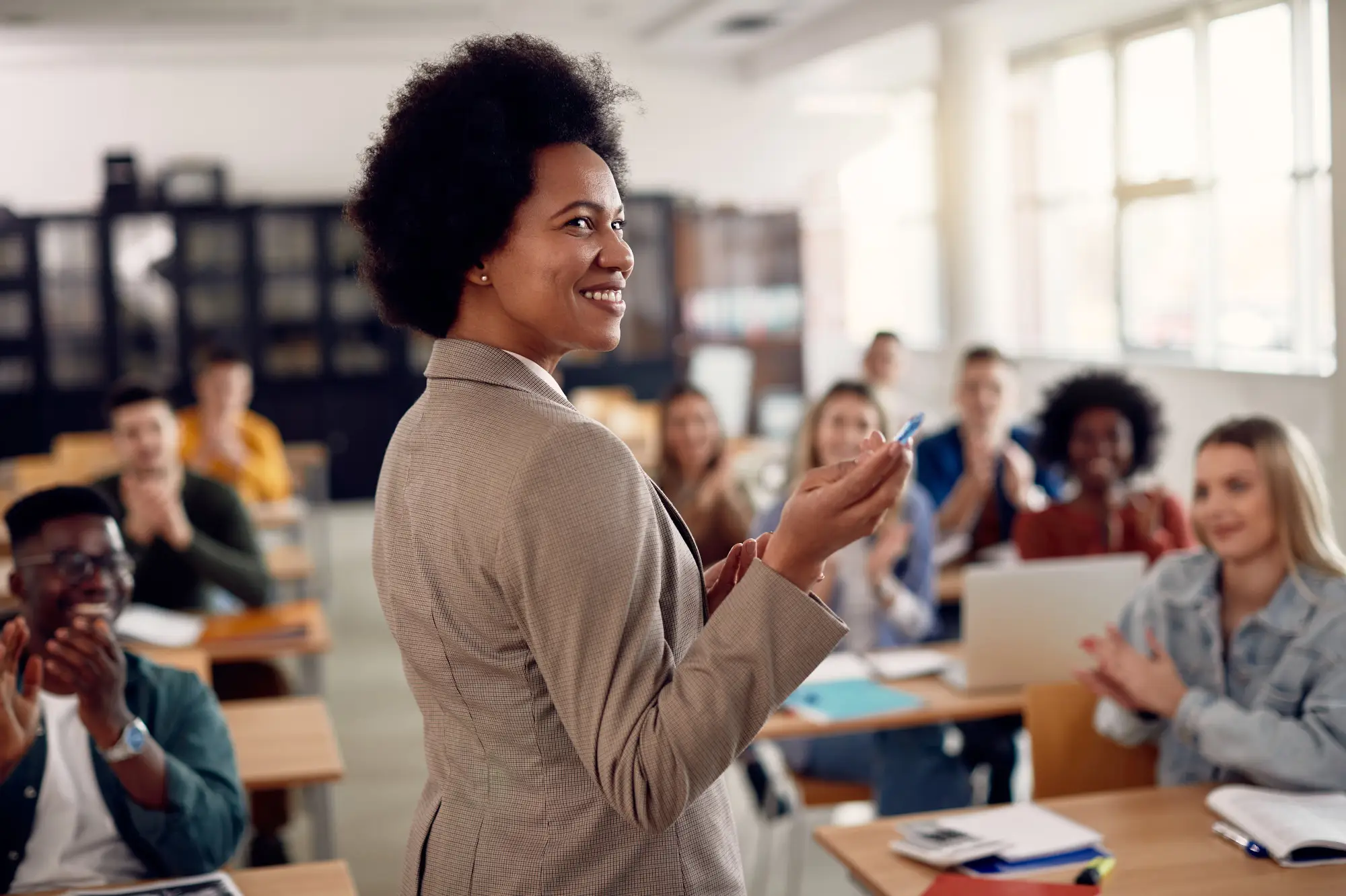 Female teacher in a school setting with students in the background