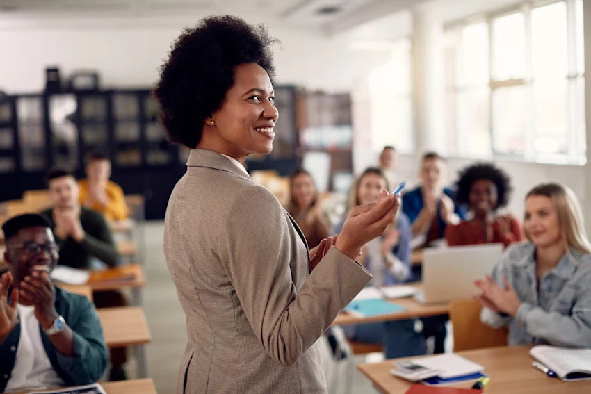 Female teacher in a school setting with students in the background