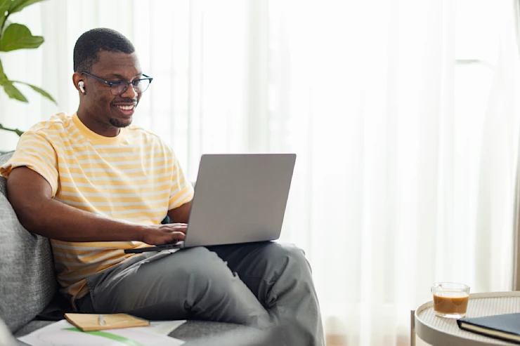 CFFP - man on couch working on laptop