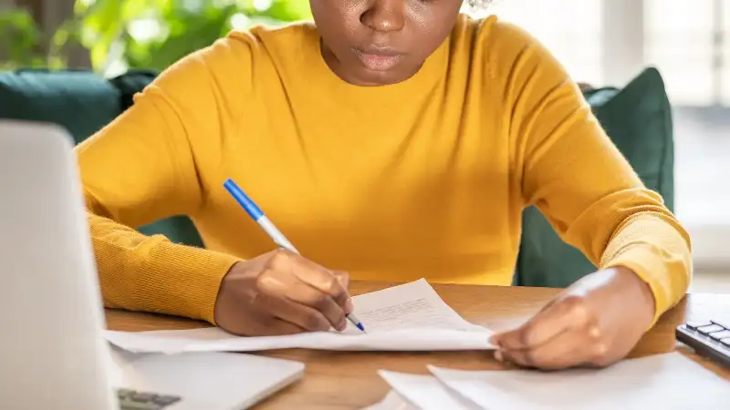 Woman at desk writing