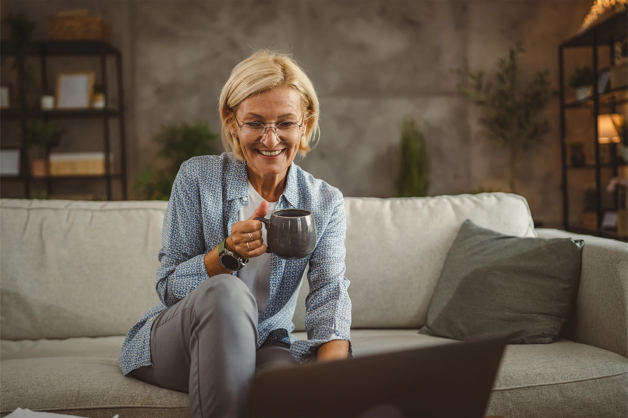 dearborn - woman on couch with laptop