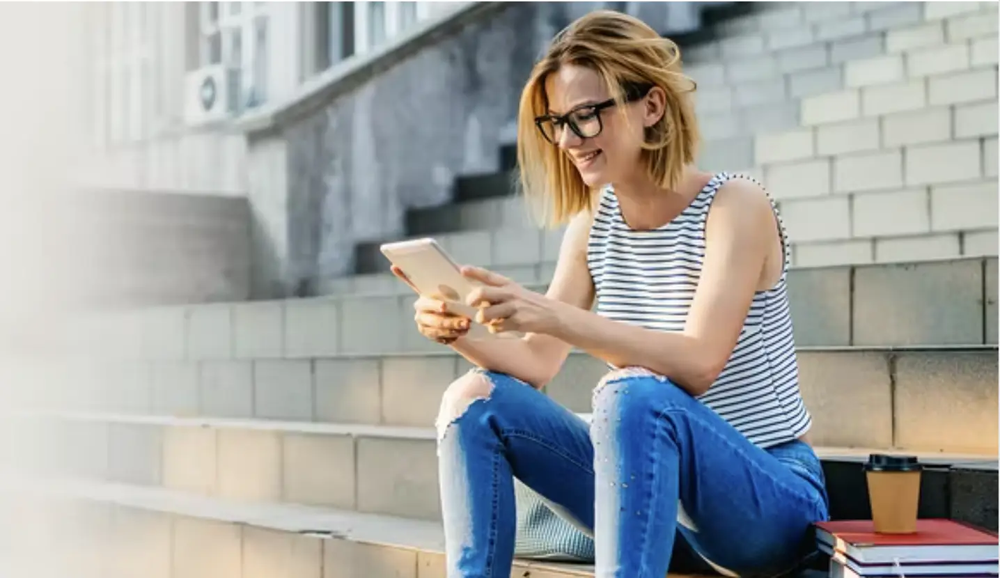 Girl sitting on steps with iPad