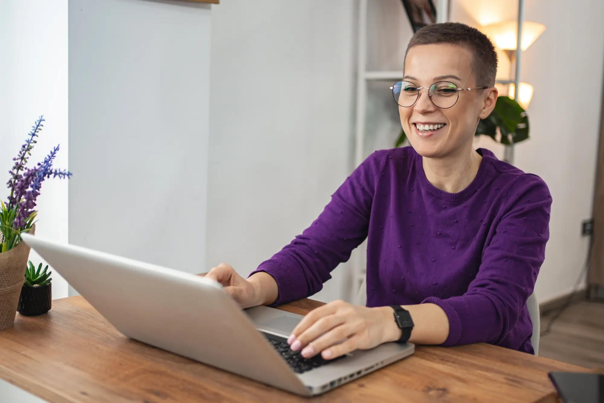 woman at home at table on laptop