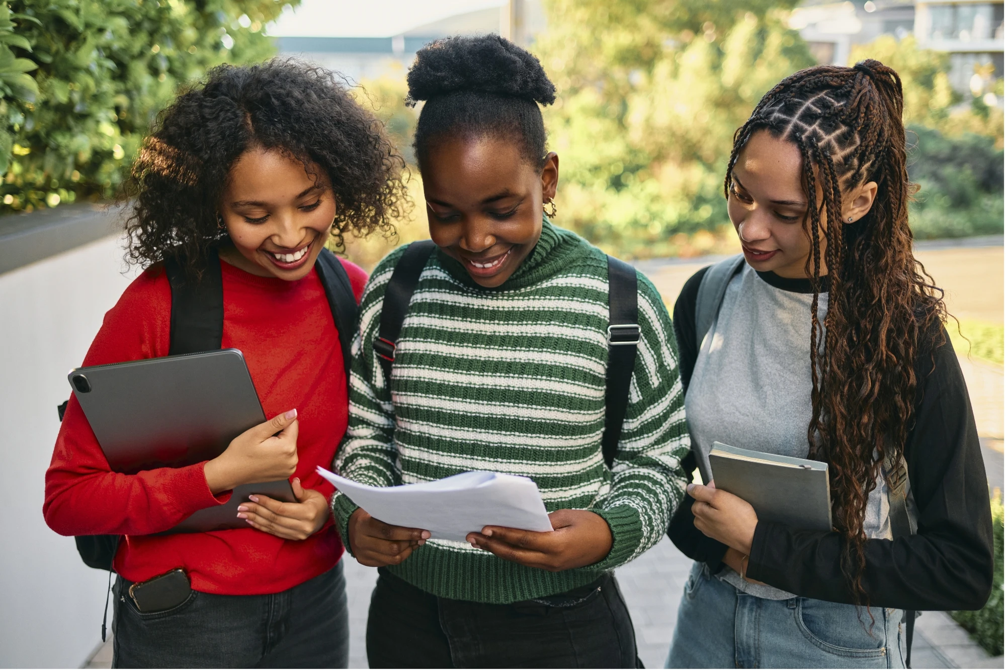 Students outside on campus reviewing class notes