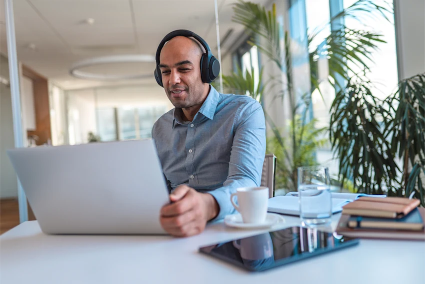 Man On Laptop With Headphones