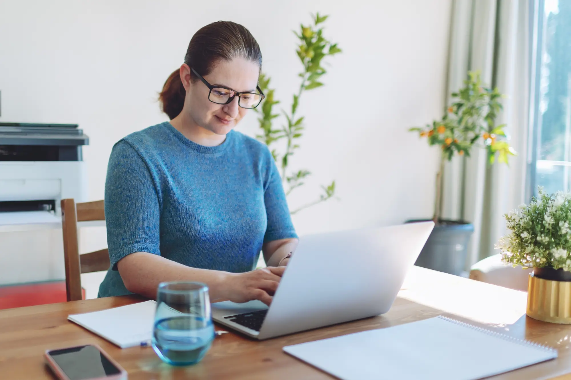 woman at home at table on laptop