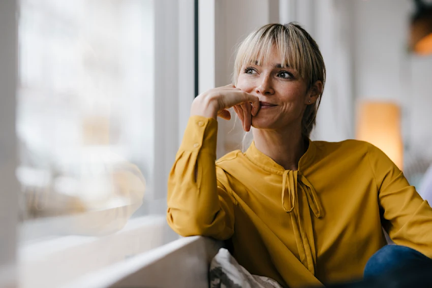 Lady smiling looking out of a window