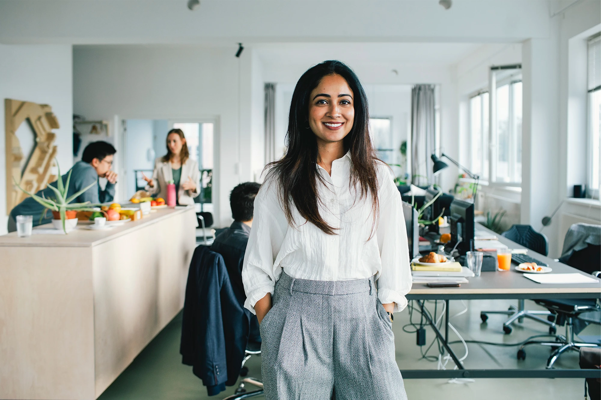 cfa-india-woman-standing-smiling-office