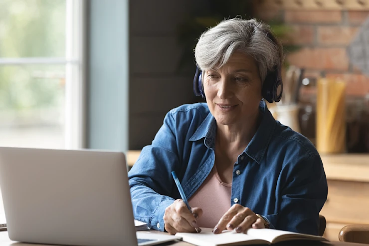 dearborn - womn on laptop with headphones