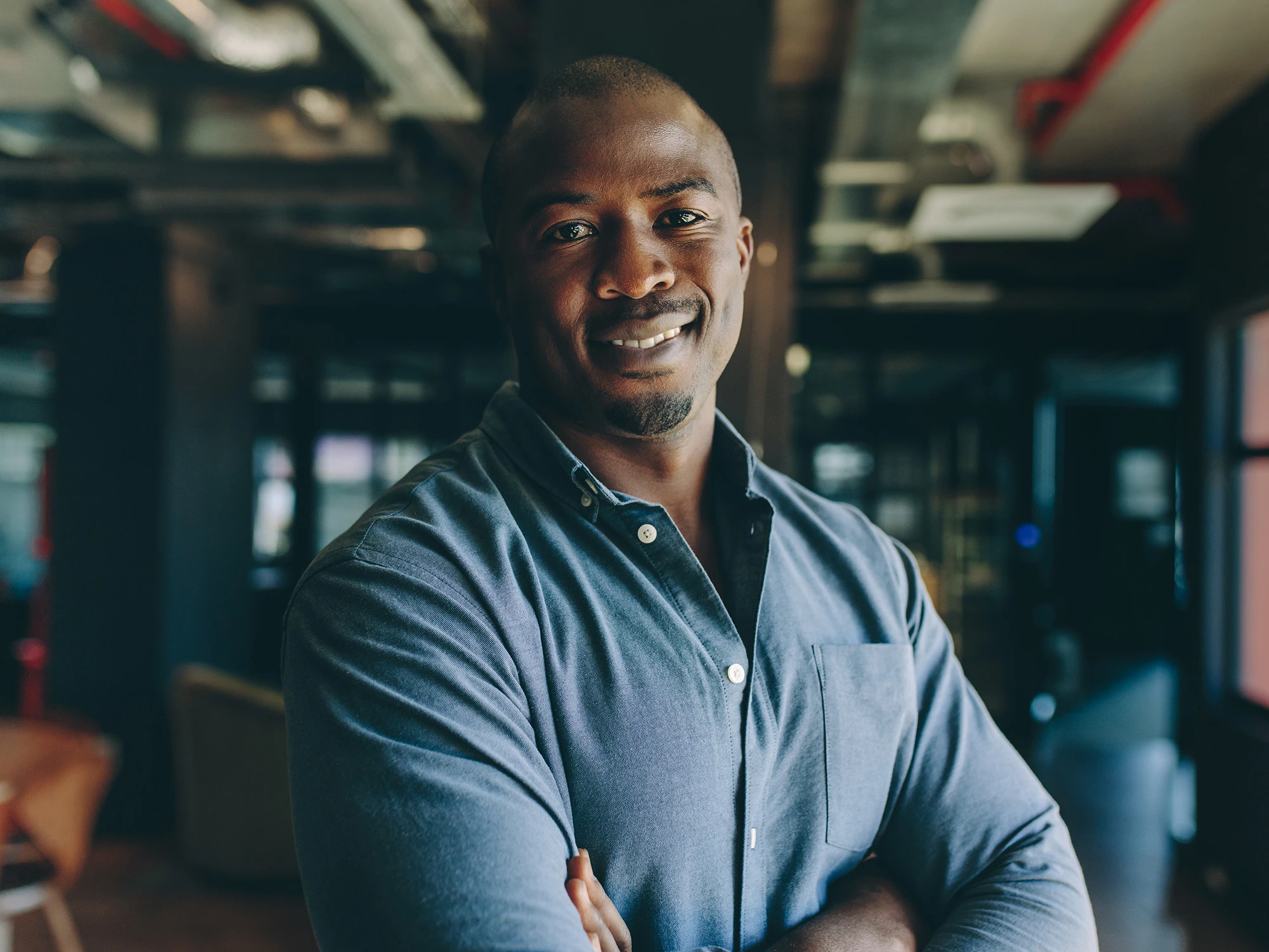Male student standing in work environment