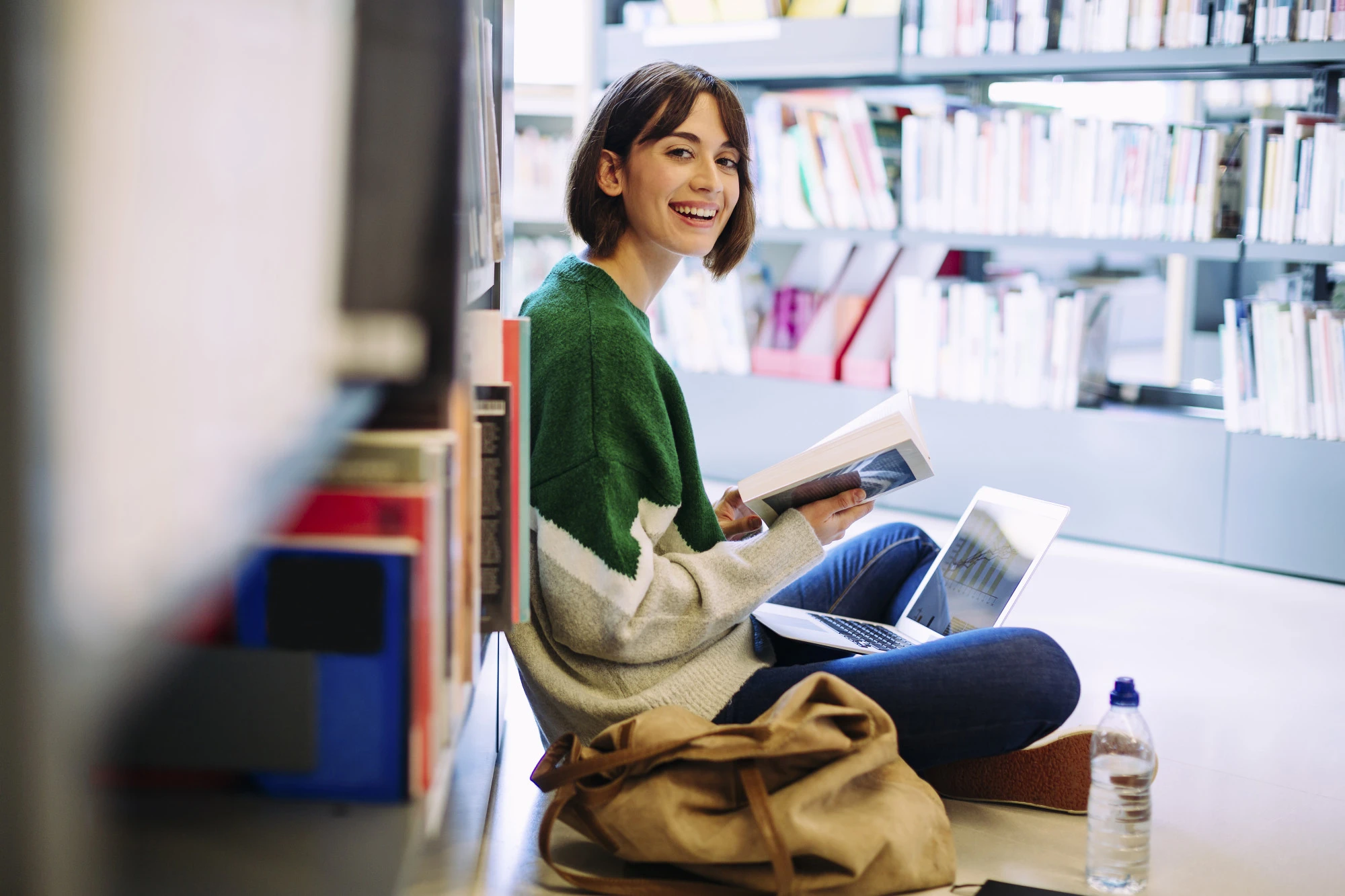 Smiling female student in a library