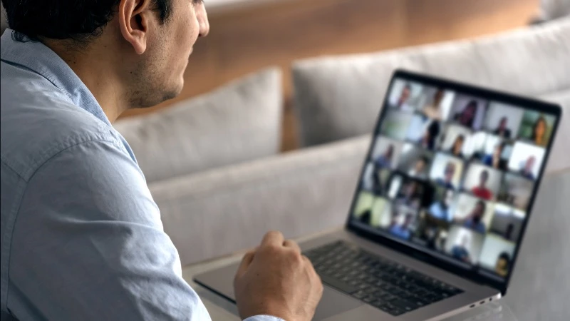 Business person in online meeting on laptop computer
