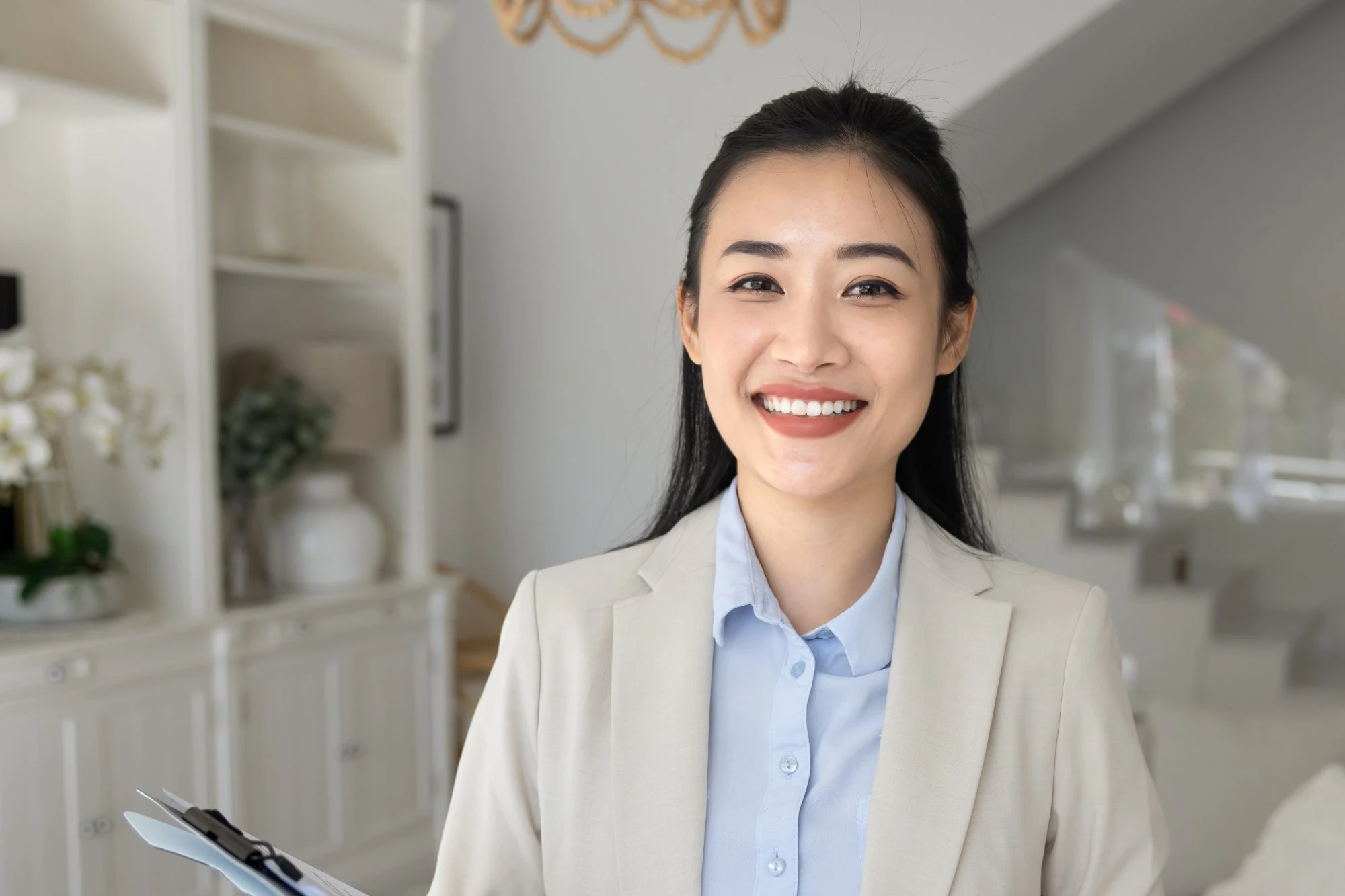 real estate agent woman in a suit smiling 