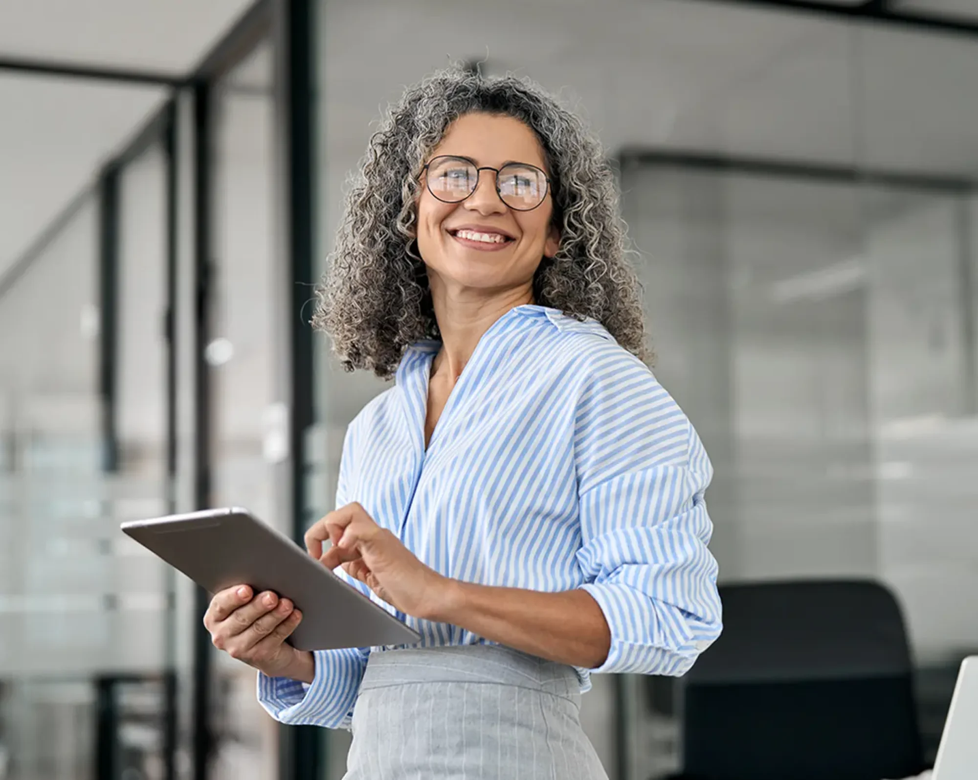 happy hr woman completing payroll on tablet