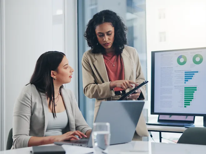 Professional business women reviewing financial report