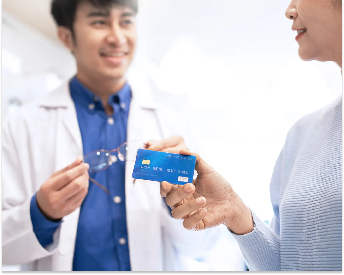 woman using hsa card to pay for glasses