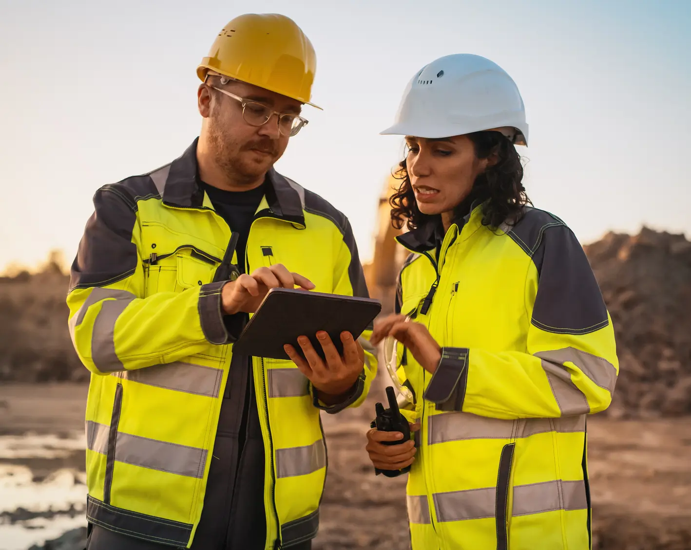 construction workers on site looking at a tablet