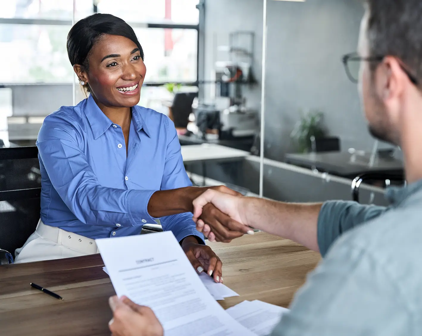 woman shaking hands with man