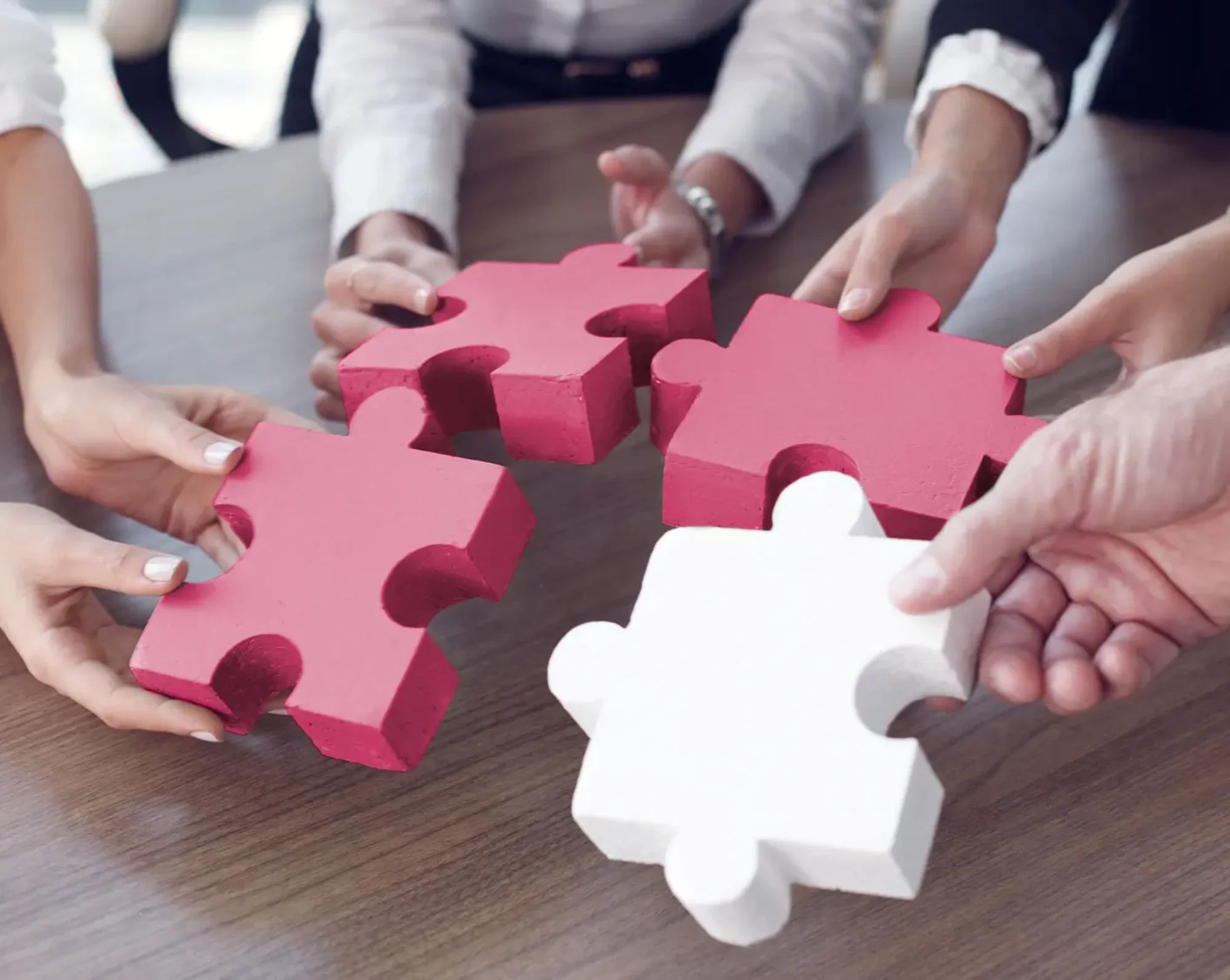 hr employees holding puzzle pieces
