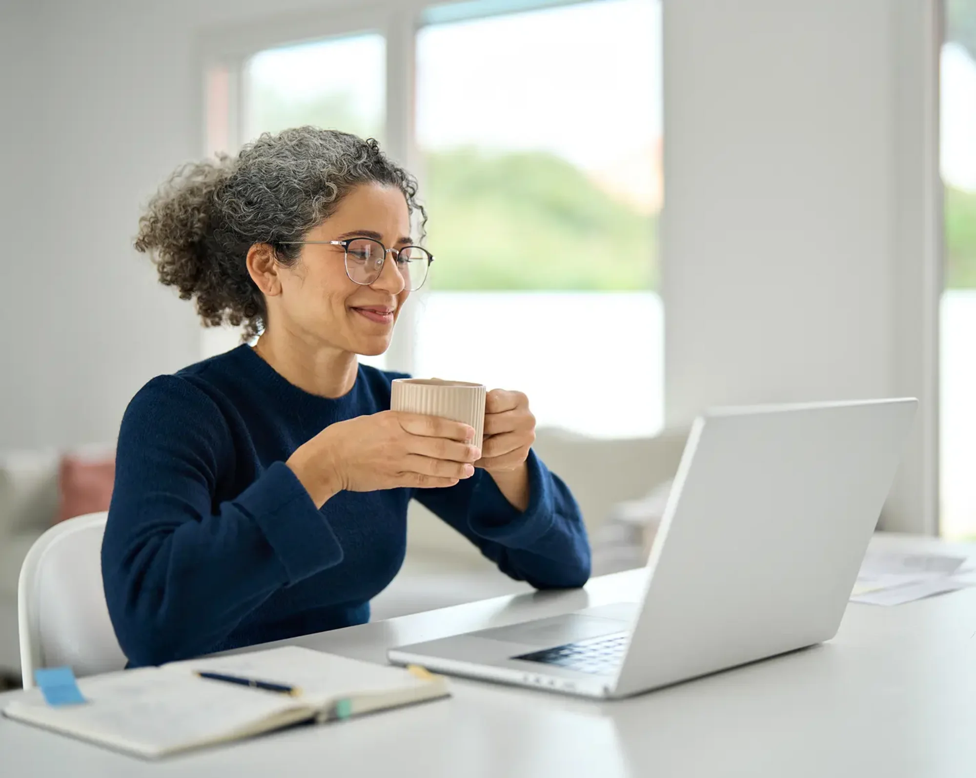 happy woman looking at 401k info on computer