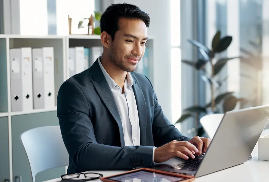 man at computer looking over leave management benefits