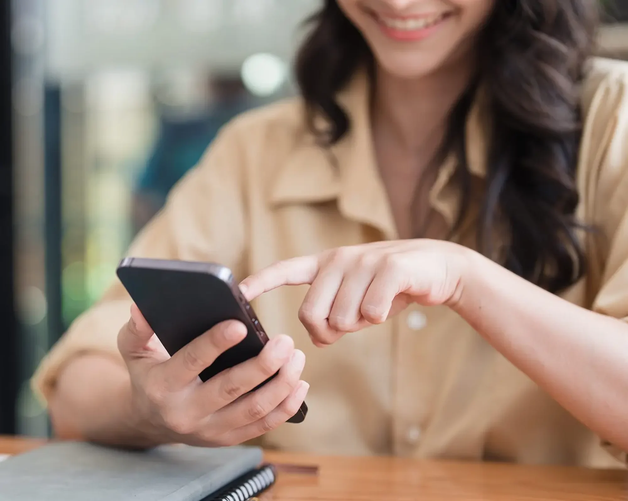 employee looks on phone at healthcare options