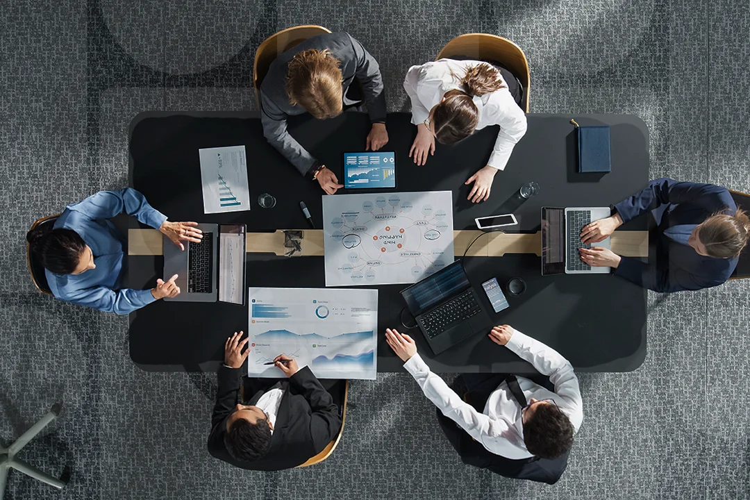 Top-down image of office workers at a desk
