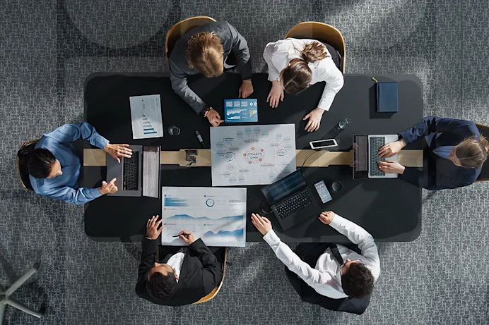 Top-down image of office workers at a desk