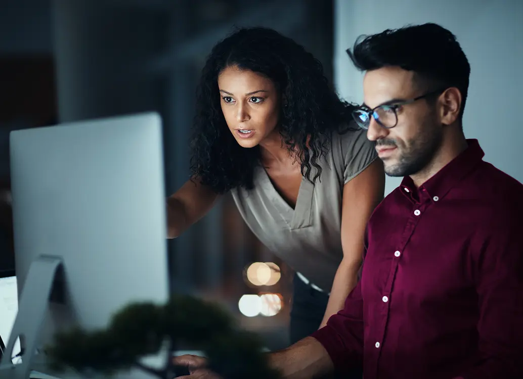 coworkers figuring out payroll on computer