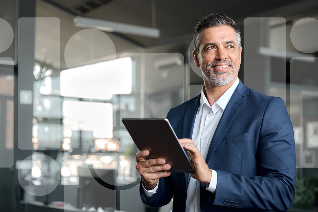 Man at the office looking at an iPad 