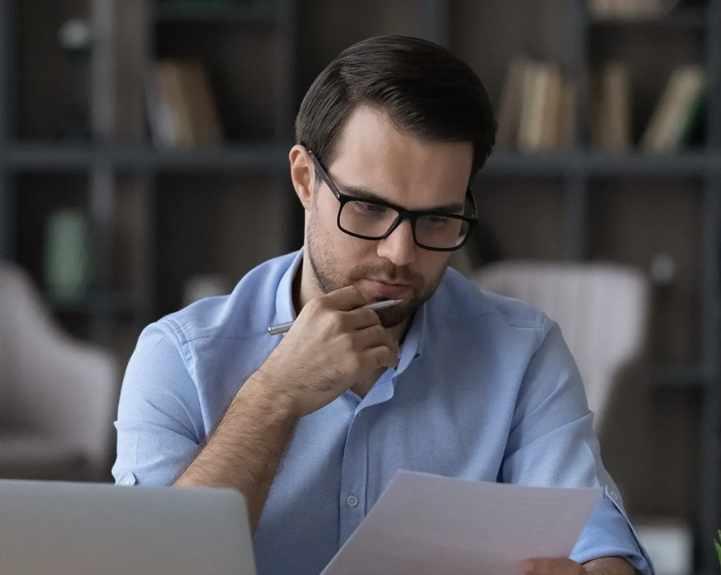 man at home office looking over benefit options