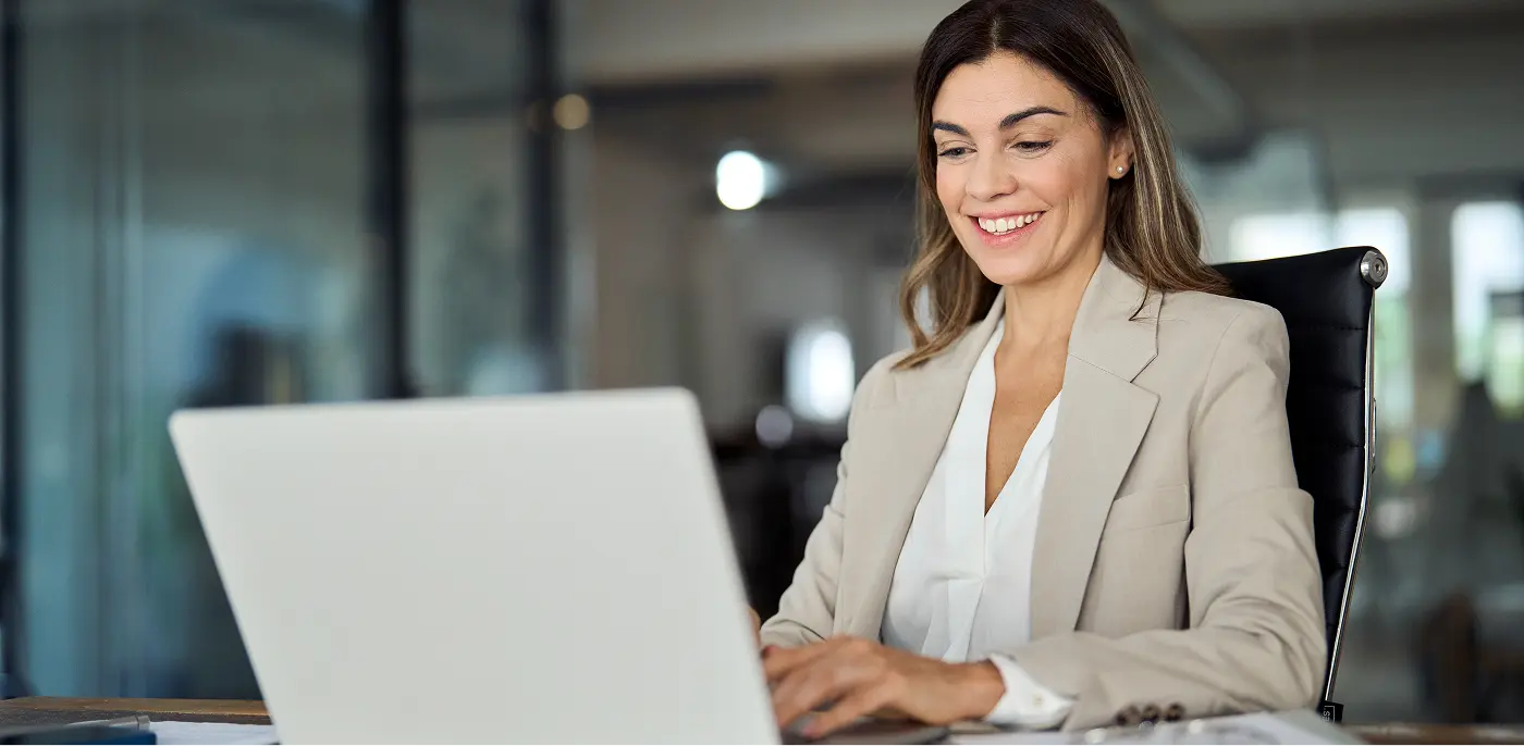 manager on computer communicating schedules to workers