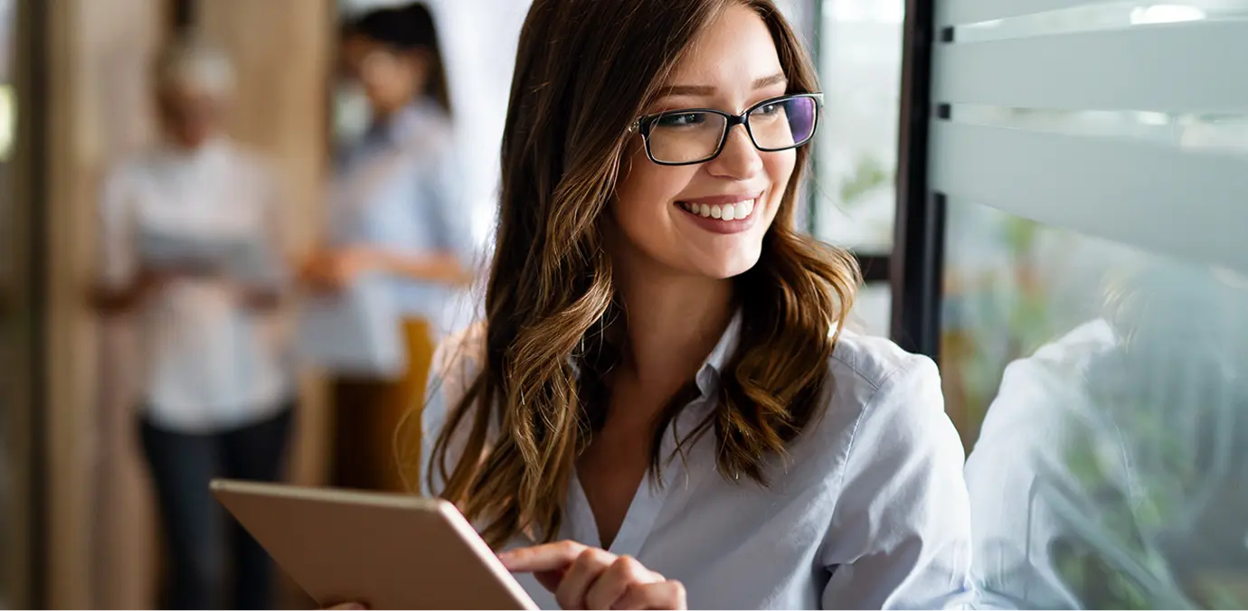 woman looking out the window as she manages payroll processing