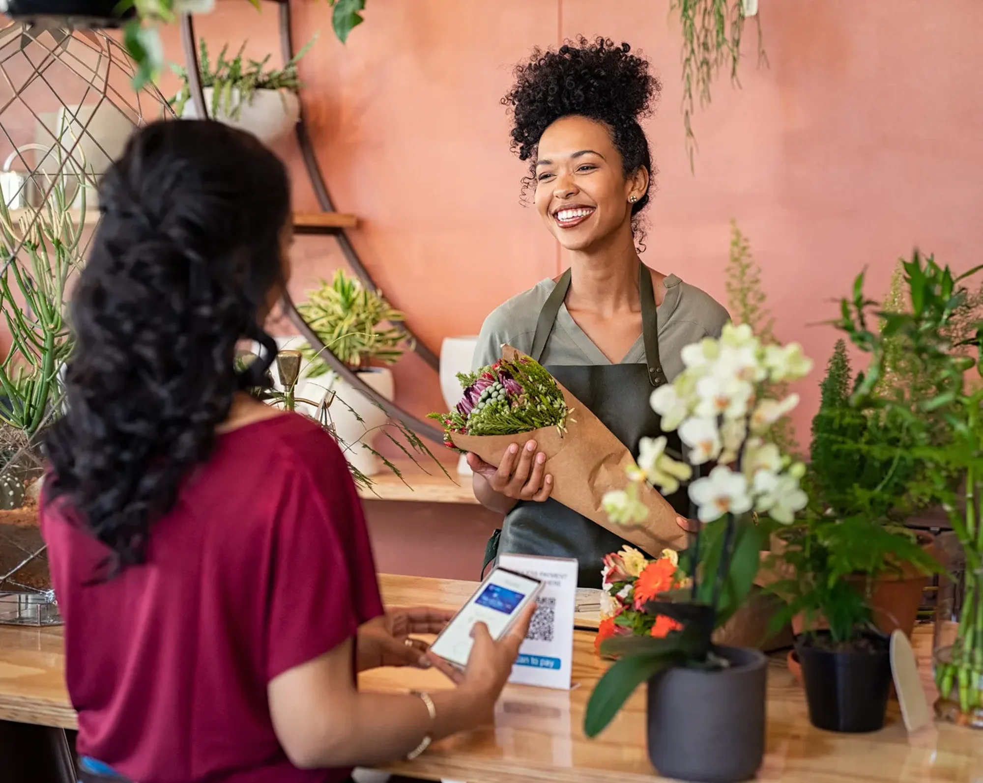 flower shop employee helping customer