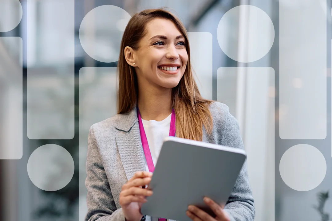 Smiling woman with lanyard and laptop