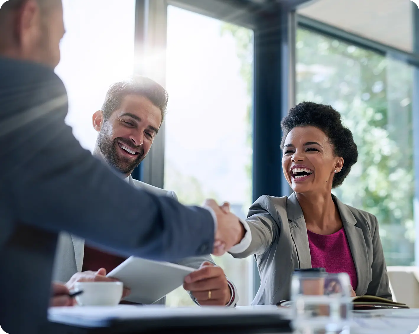 couple shaking hands with financial advisor